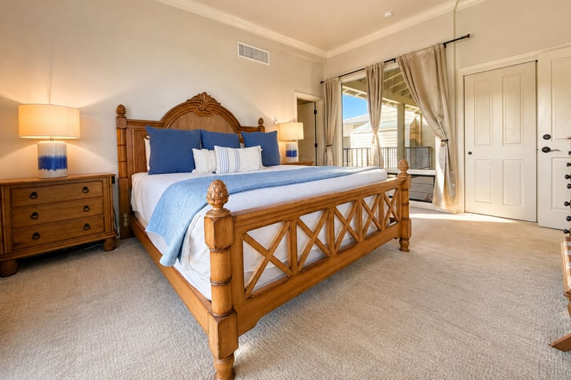 A second lanai door and a dresser with reading lamps round out your primary bedroom, steps from its own ensuite bathroom.