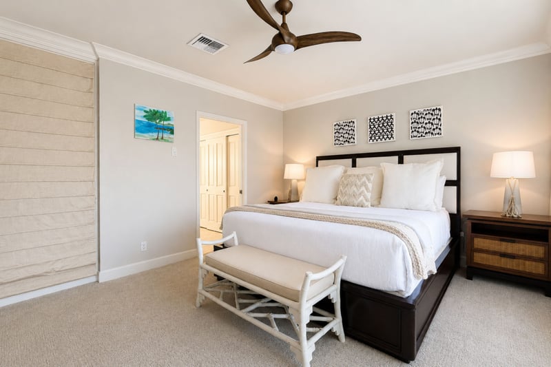 A dresser, ceiling fan, and blackout shade complete your second bedroom, with a closet just outside the door for extra storage.