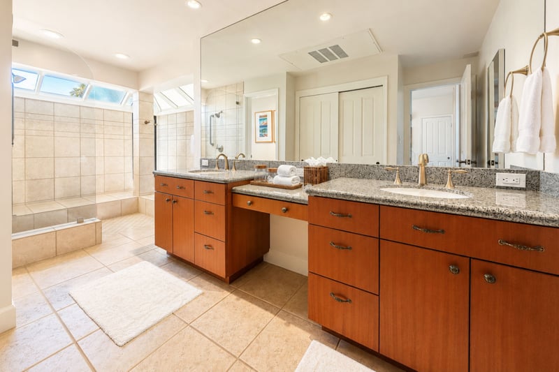 Your primary bathroom offers a dual vanity with a makeup counter between the sinks, plus a separate walk-in shower and soaking tub.