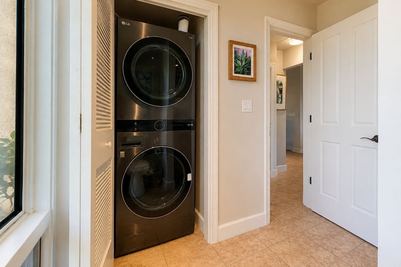 An in-residence washer and dryer stack in a hallway closet, letting you pack lighter and refresh beachwear during your stay.