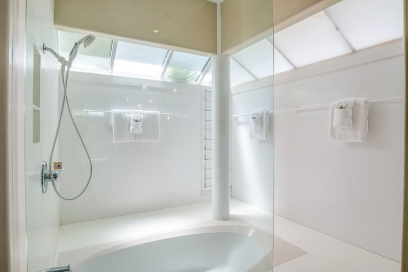 Luxurious details like soft tile, deep soaking tub, and expansive counter space elevate your stay