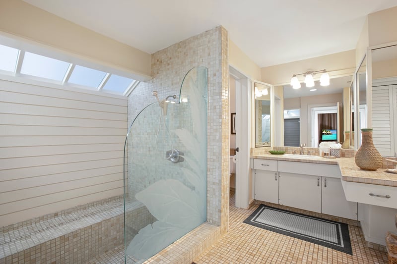 Start your day surrounded by mirrors and natural light in this bright, breezy bathroom with spa-style tiles and a chic coastal vibe!   