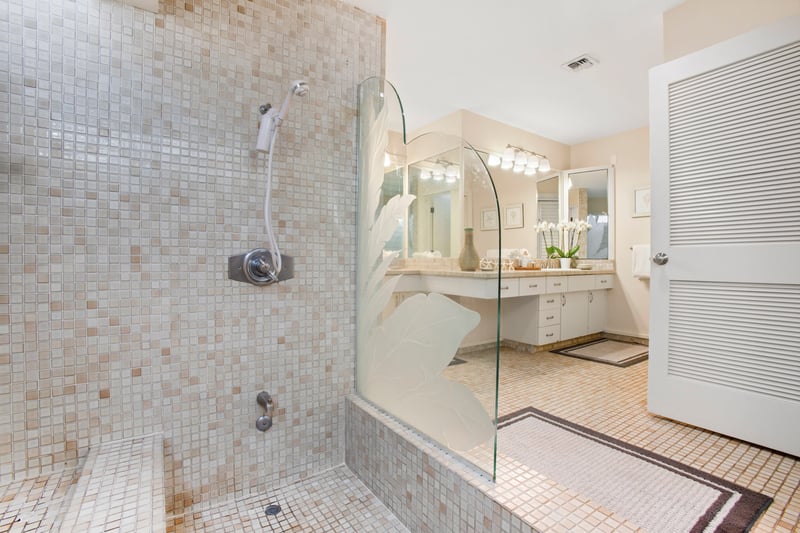 Whether it’s a quick rinse or a long soak, this tranquil tiled shower under skylight beams makes it all feel like a treat   