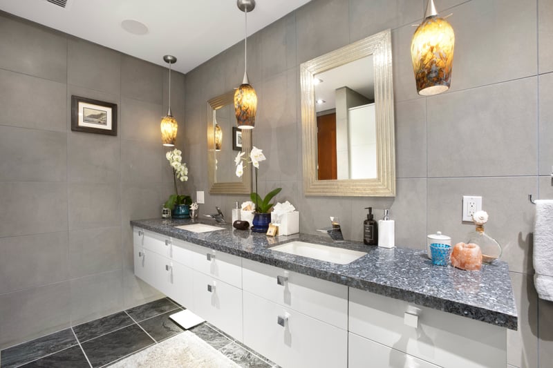 Get ready in style under amber lights, surrounded by stone elegance and a shower that feels like a private waterfall retreat