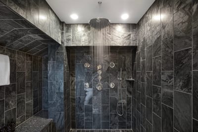 Who says guest bathrooms can’t steal the show? With rich textures and a double shower, this one brings all the wow