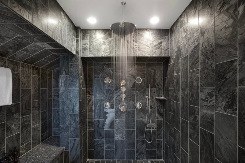 Who says guest bathrooms can’t steal the show? With rich textures and a double shower, this one brings all the wow