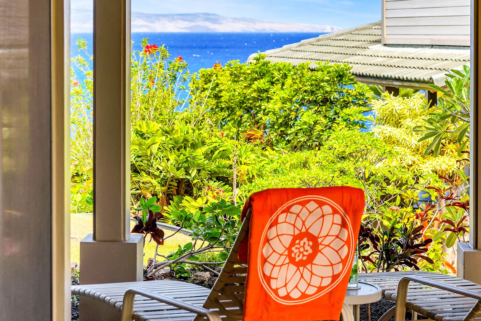 Beautiful garden-level view with lush tropical landscaping, open green space, and a clear sightline to the deep blue ocean, creating a serene and private setting.