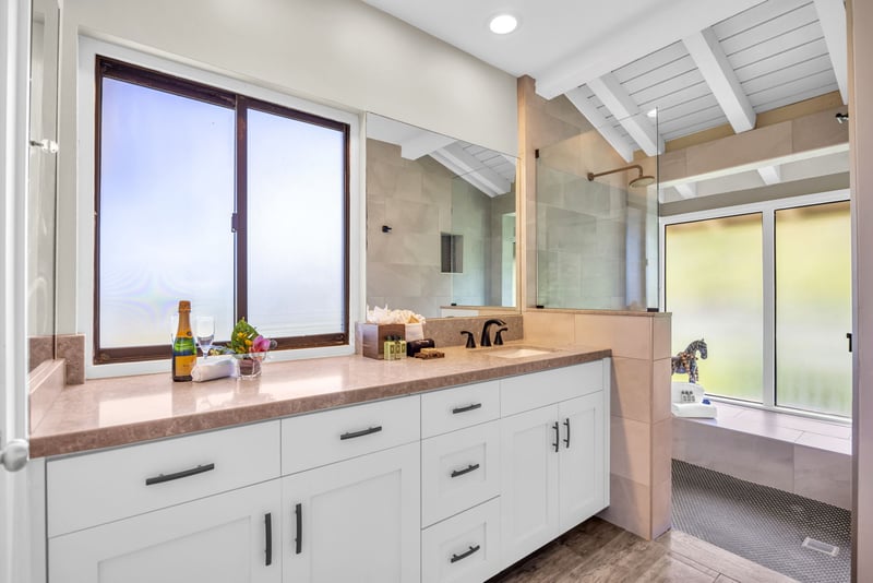 A modern en-suite bathroom with plenty of counter space and a walk-in shower and rainfall shower head.  KBV-24G3