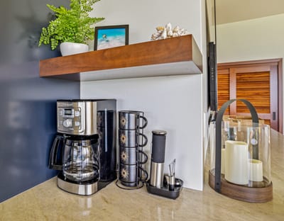 Morning coffee hits different when you're steps from the shore and the fridge is as sleek as the ocean view