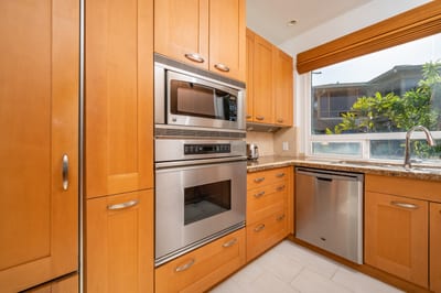 Cook in style with granite countertops, custom wood cabinetry, and large windows that bring paradise indoors KBV-28G2