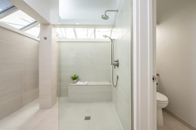 Step into luxury in this spa-inspired master bath, featuring a walk-in glass shower, granite counters, and natural light KBV-28G2