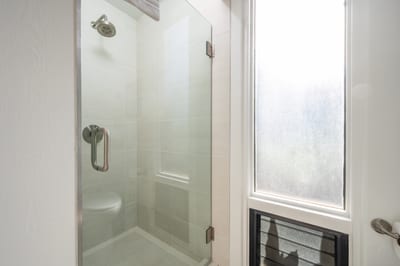 Refresh in a bright, modern bathroom with granite counters and walk-in shower