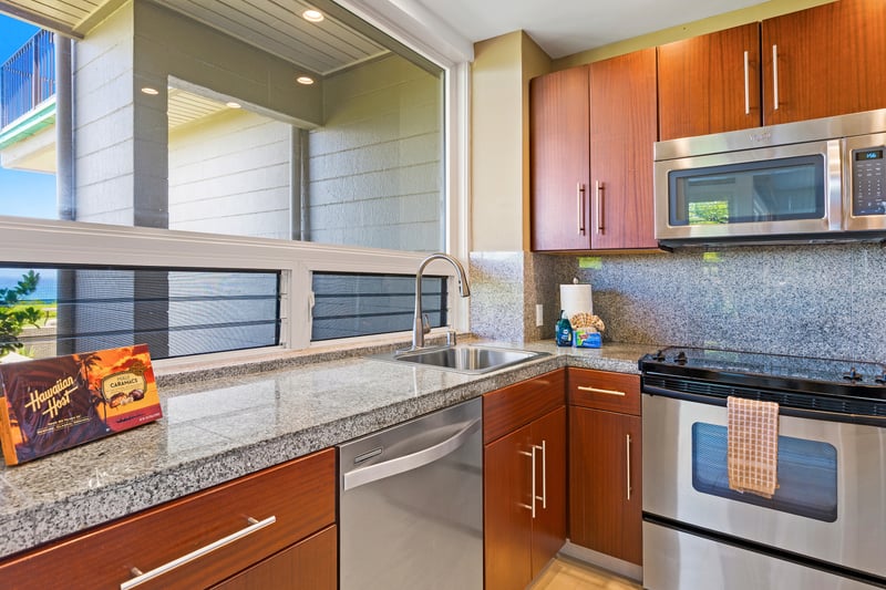 Cook with ease in this fully equipped kitchen featuring sleek appliances and granite counters KBV-30G2