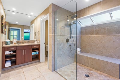 Unwind in this polished bathroom with walk-in glass shower and calming neutral tones