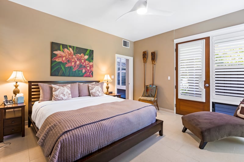 Elegant king suite featuring island-style decor, soft lighting, and serene outdoor access KBV-30G2