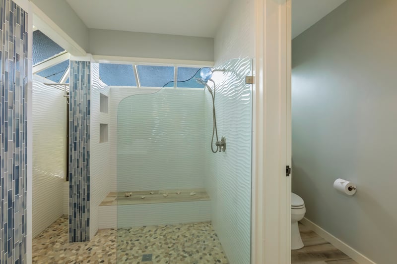 Step into a bathroom oasis with clean design, spacious layout, and thoughtful comfort-focused details