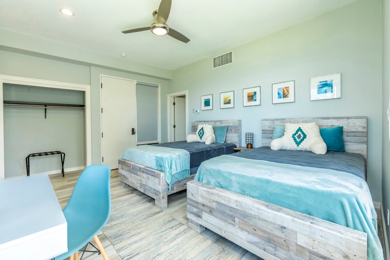 With calming tones and contemporary coastal design, this guestroom invites rest, light, and relaxation