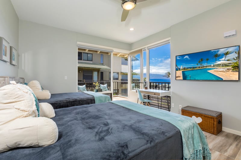 This spacious guestroom features two plush beds, modern decor, and a private lanai perfect for morning coffee