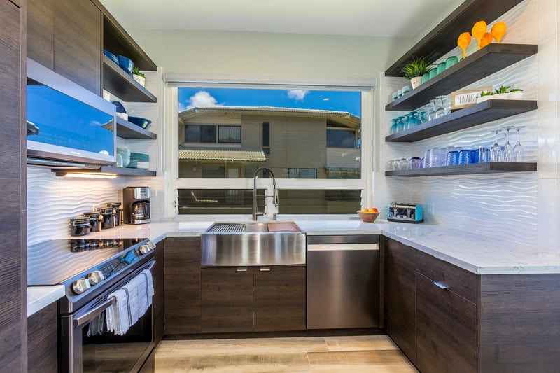 A kitchen that inspires—from the ocean-facing bar top to soft-close cabinets and a chef-ready layout