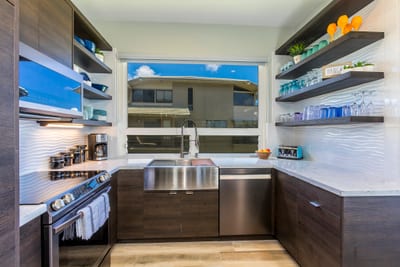 A kitchen that inspires—from the ocean-facing bar top to soft-close cabinets and a chef-ready layout