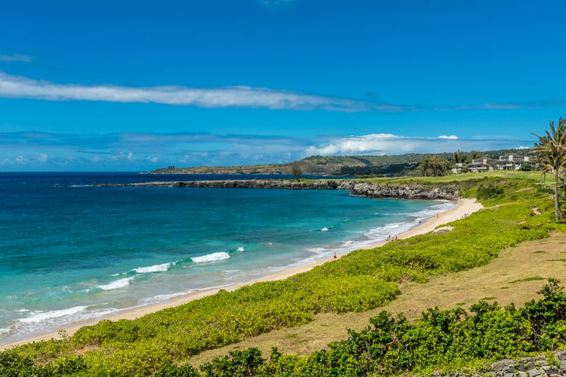 Where golden sands curl along turquoise waves and lava rock juts proudly into the glistening Pacific horizon
