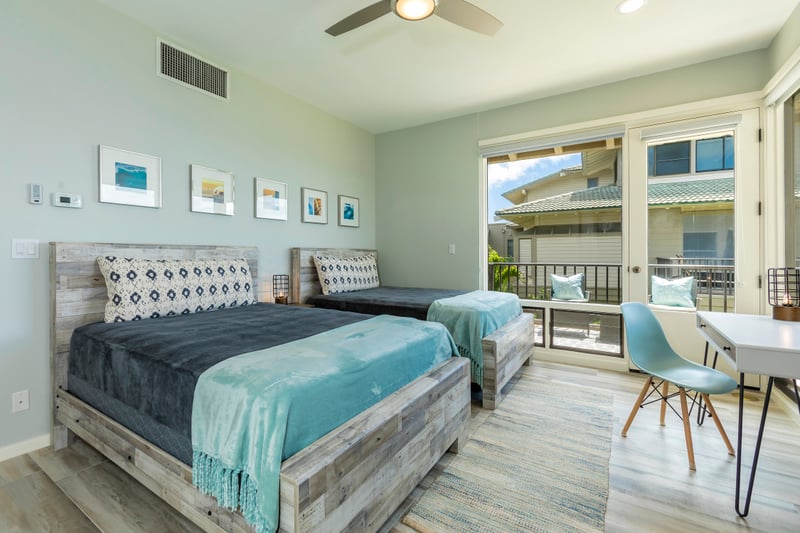 A tranquil guestroom with lanai access, ocean views, and crisp design—ideal for guests seeking space and style