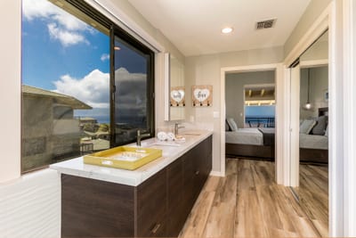 Begin and end your days in style with a double vanity, open views, and a relaxing rain-style shower