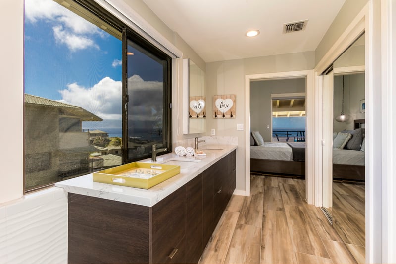 Begin and end your days in style with a double vanity, open views, and a relaxing rain-style shower