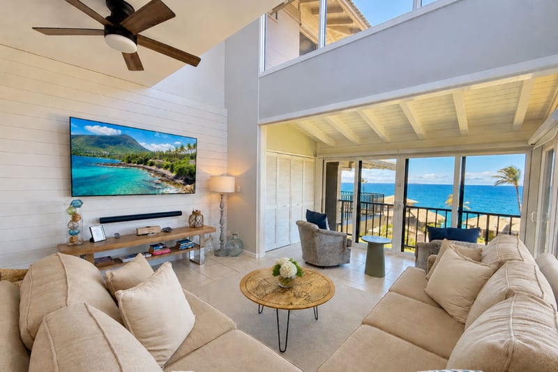 Your open living area pairs comfortable seating with expansive windows and ocean views just beyond the balcony.