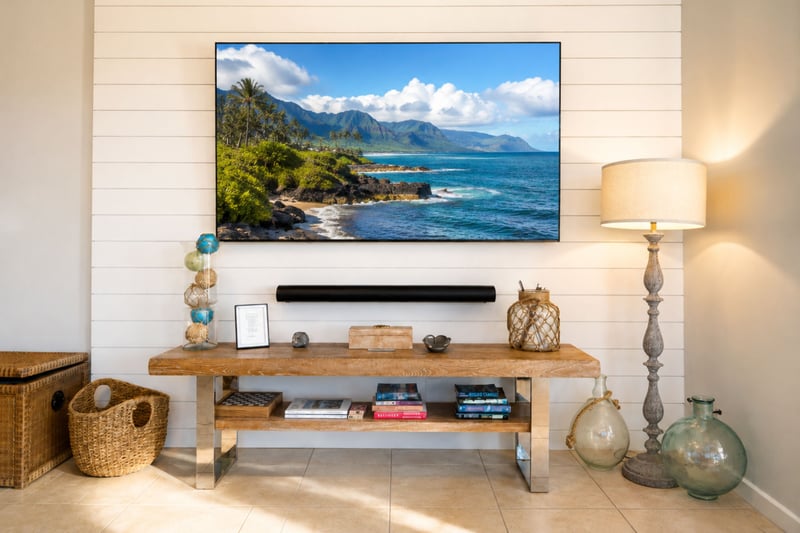 Enjoy movie nights from your comfortable living area, complete with a large TV and bright coastal surroundings.