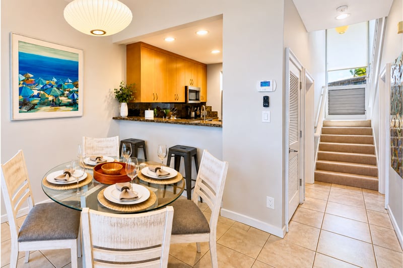 Your dining area sits beside the kitchen for easy meals together, with warm lighting and comfortable seating.
