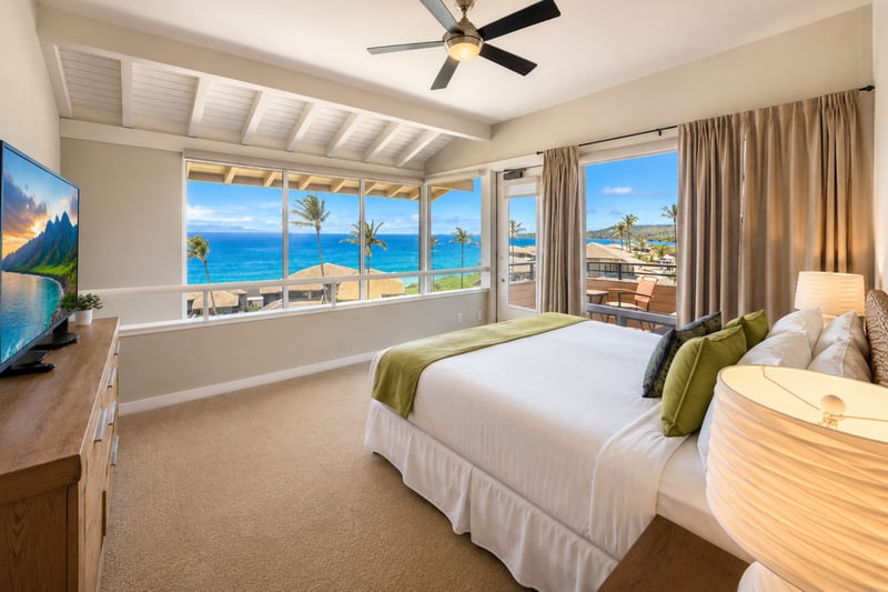 Wake to ocean views from your primary bedroom, with balcony access bringing fresh island scenery close to your bedside.