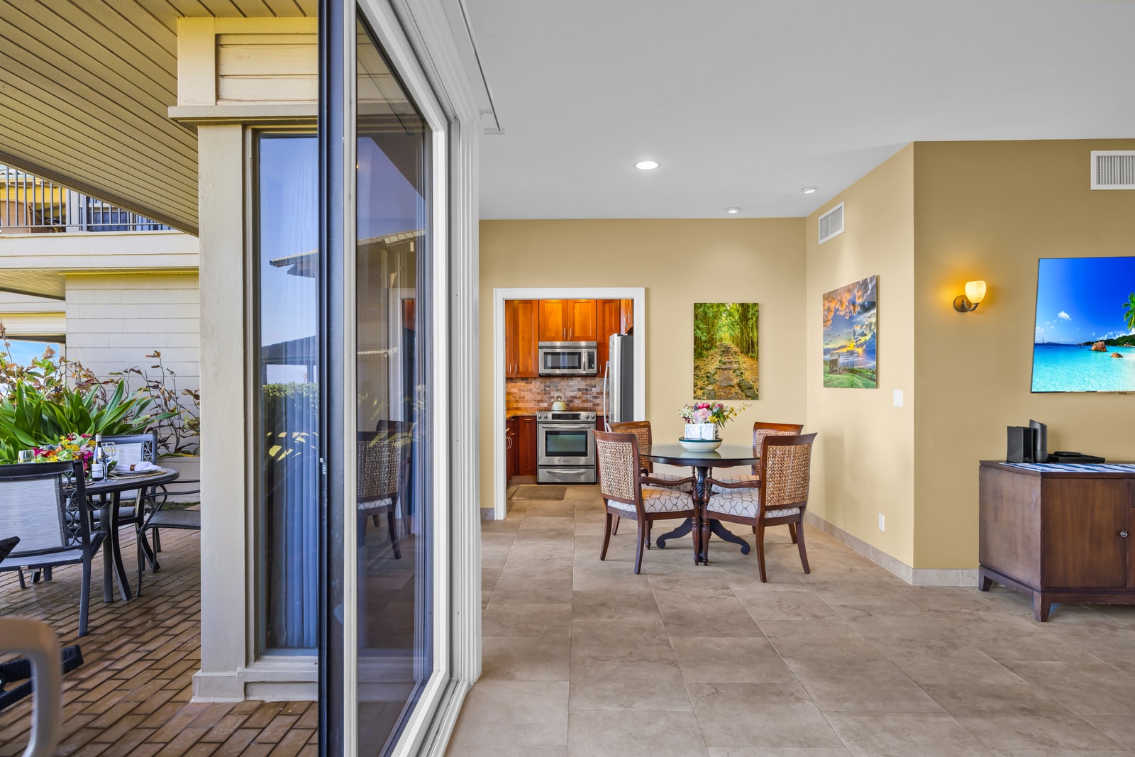 Indoor-outdoor dining flows easily from the lanai to the full kitchen.