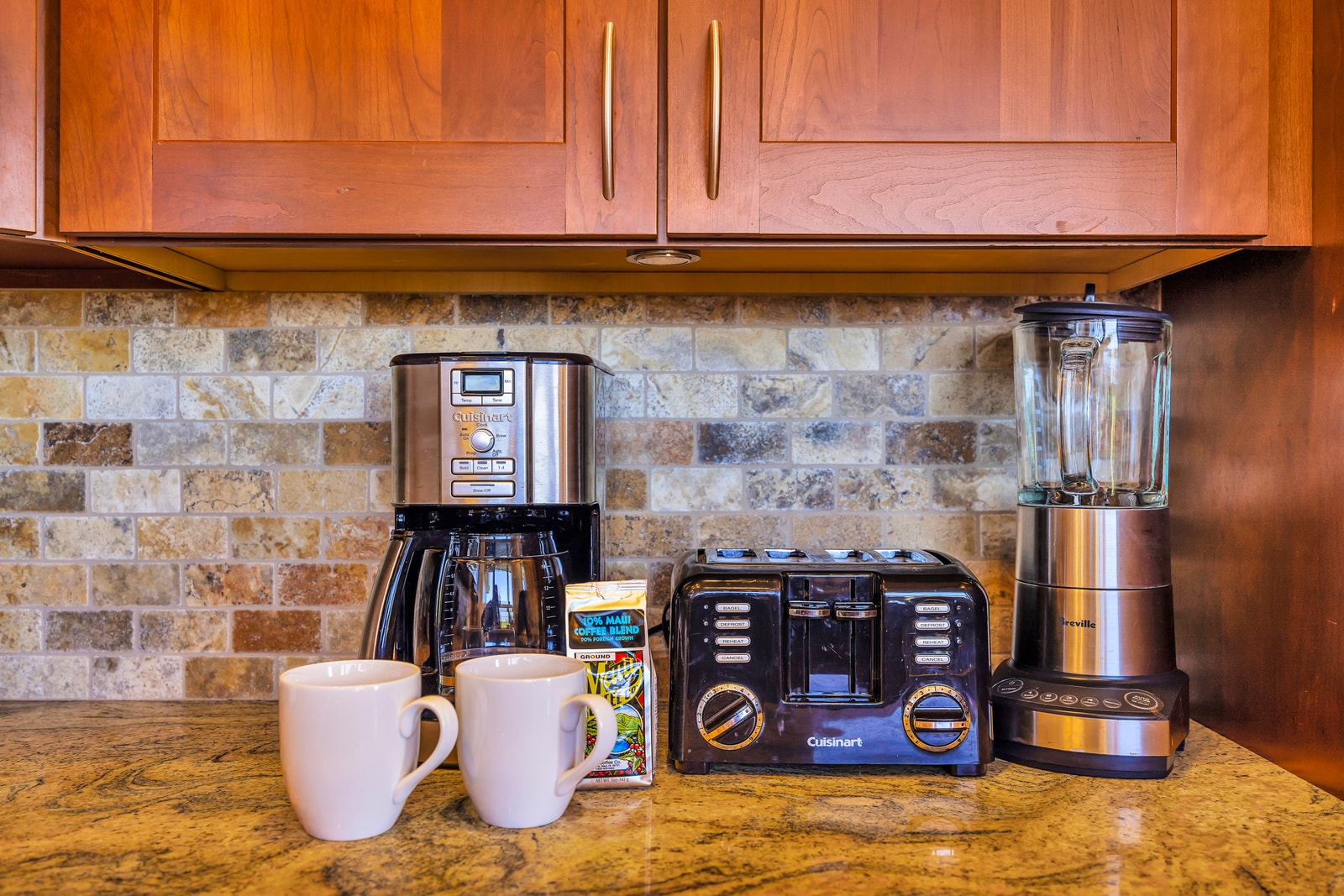 Everything you need for coffee or smoothies is ready on the granite countertop.