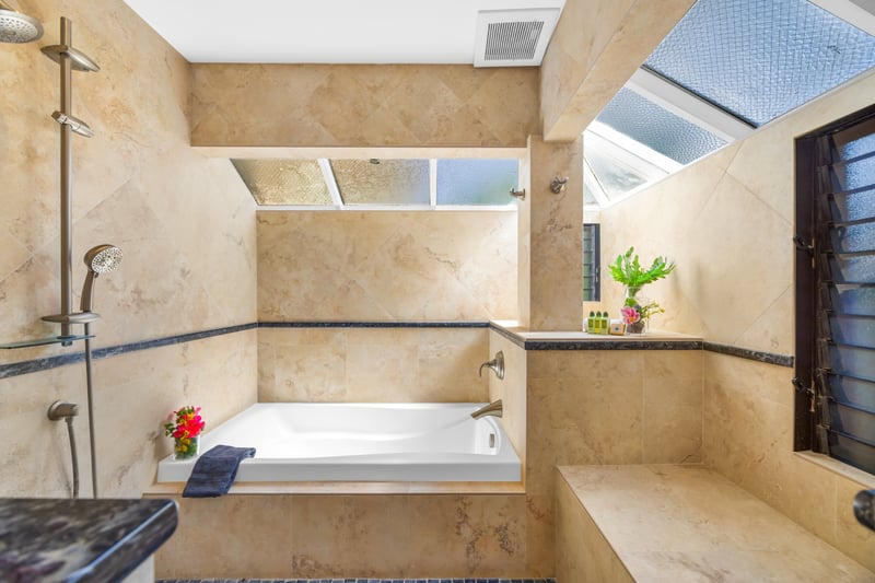 Spacious walk-in shower with glass doors adds comfort and ease after beach adventures.