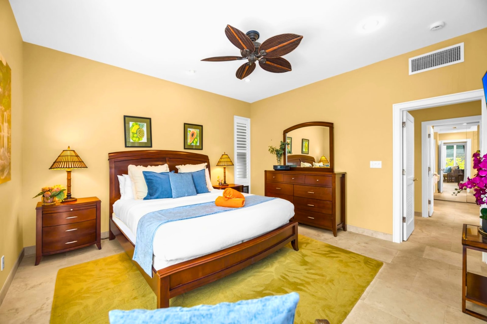 Retreat to your King bed after a beach day, with cool tile floors and a ceiling fan above.