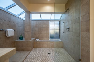 Skylit luxury with dual vanities and a spa-style walk-in shower, where mornings start in peace and style