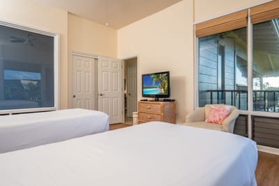 Invite restful nights in this inviting guest retreat with twin beds, scenic windows, and warm coastal textures