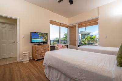 A guest bedroom thoughtfully styled with calming hues, generous natural light, and modern comforts throughout