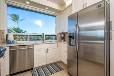 Palm trees wave hello while you prepare breakfast in a space that feels both efficient and effortlessly fresh