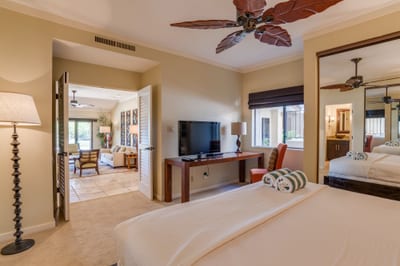 Drift into dreamland beneath tropical blades and soft lighting—this master bedroom wraps you in warmth and island ease KGV-14P3