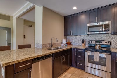 This rich, espresso-toned kitchen isn’t just functional—it’s the heart of your stay, where every meal feels like home KGV-14P3