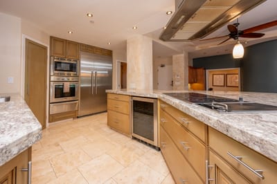 With warm tones, a sleek backsplash, and pro-grade appliances, this kitchen blends beauty and function in every detail