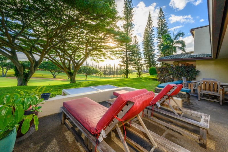 Lounge in the dappled sunlight, where towering trees frame your view and the greens roll out like a natural painting