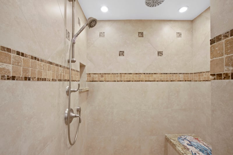 With its frameless shower, granite surfaces, and modern comforts, this guest bathroom is both functional and refreshingly luxurious    