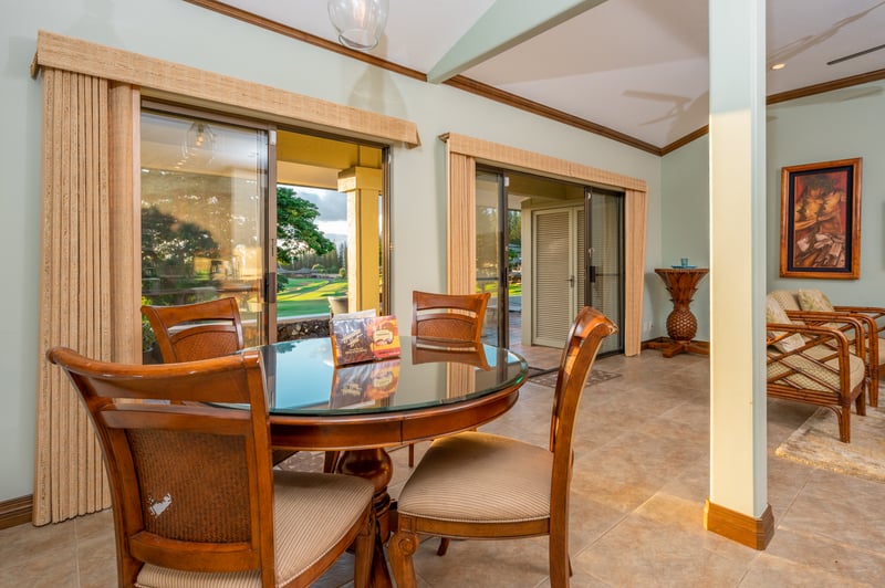 Charming dining area with glass table and scenic outdoor views. KGV-16P3