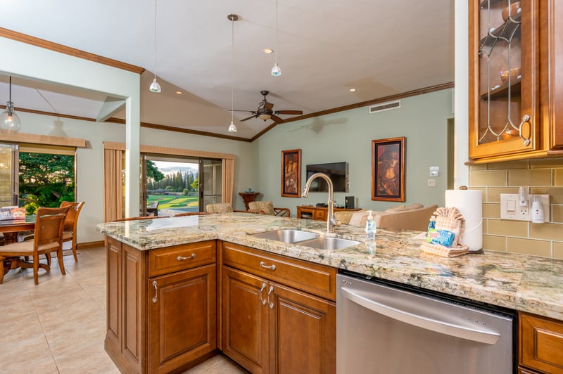 Open-concept kitchen with granite island and scenic living room views. KGV-16P3