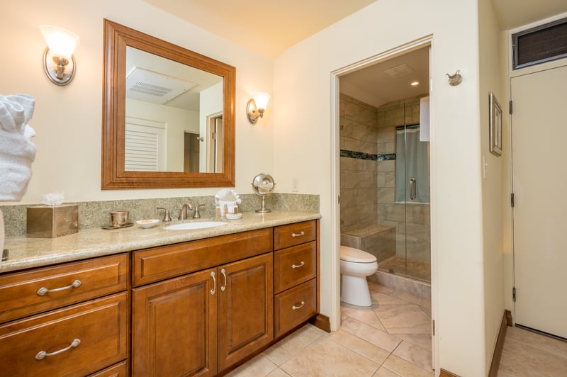 Get ready, wind down, or simply admire the glow—this bathroom's warm wood charm and glass shower are the definition of cozy chic KGV-16P3