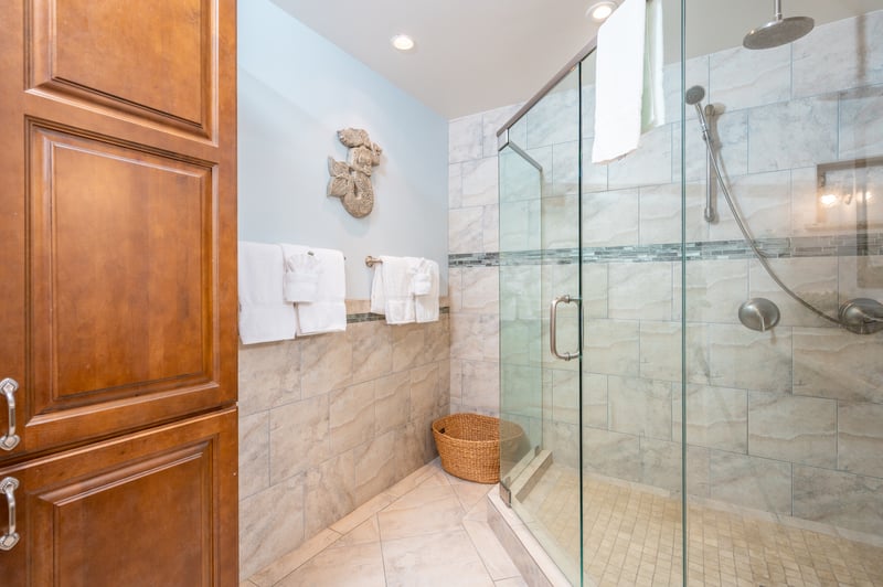 Granite gleams, towels await, and the walk-in shower calls—your guest bath story starts and ends with peaceful simplicity