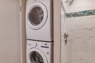 Tucked Away, Ready to Tackle Laundry: Compact washer/dryer set in a quiet corner for guest convenience KGV-17T5